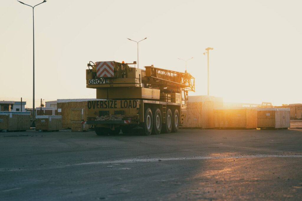 A construction crane at a Libyan site during sunset, emphasizing industry and development.